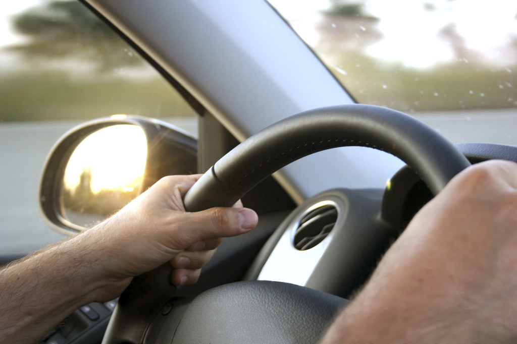 close up on steering wheel driving sunny day