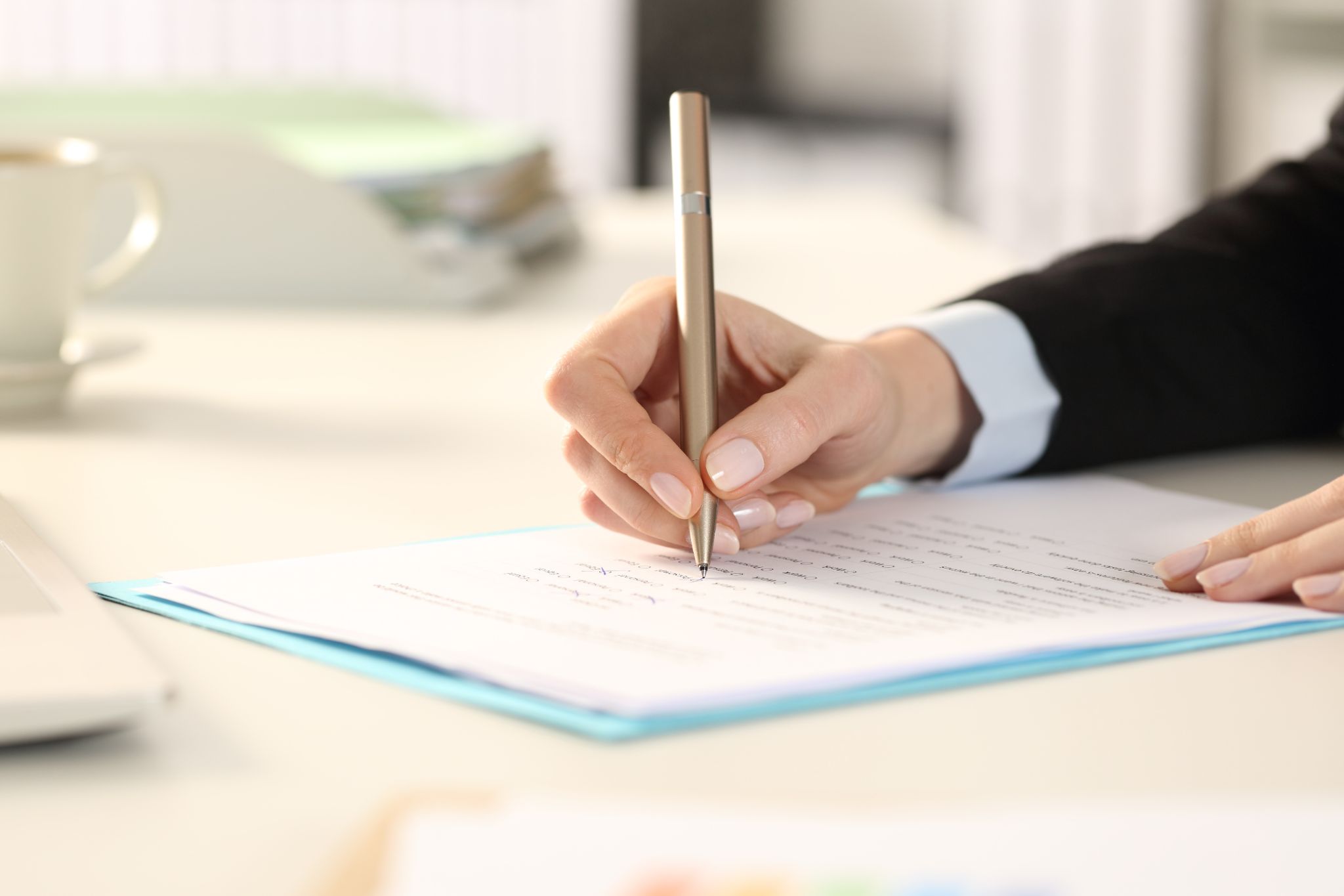 business woman hands filling out form sitting on a desk in the office