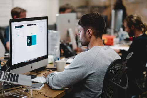 Man working on computer in open office