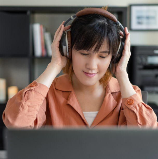 Young adult asian woman listen to music
