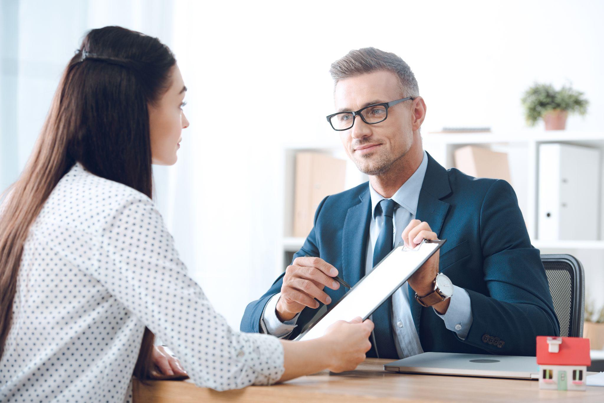 Insurance agent helping a client in a office