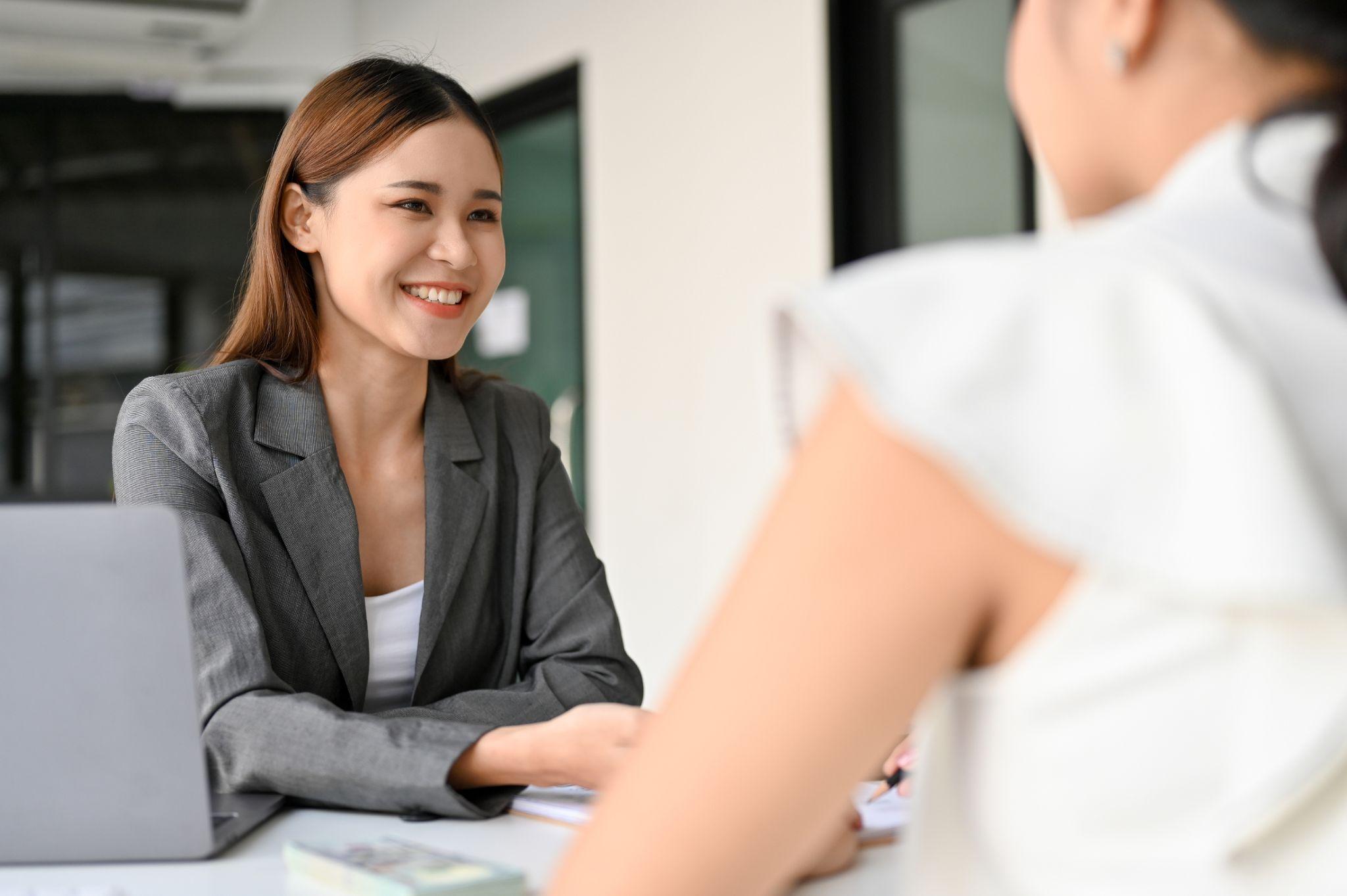 Asian female business consultant or insurance agent meets with her female client