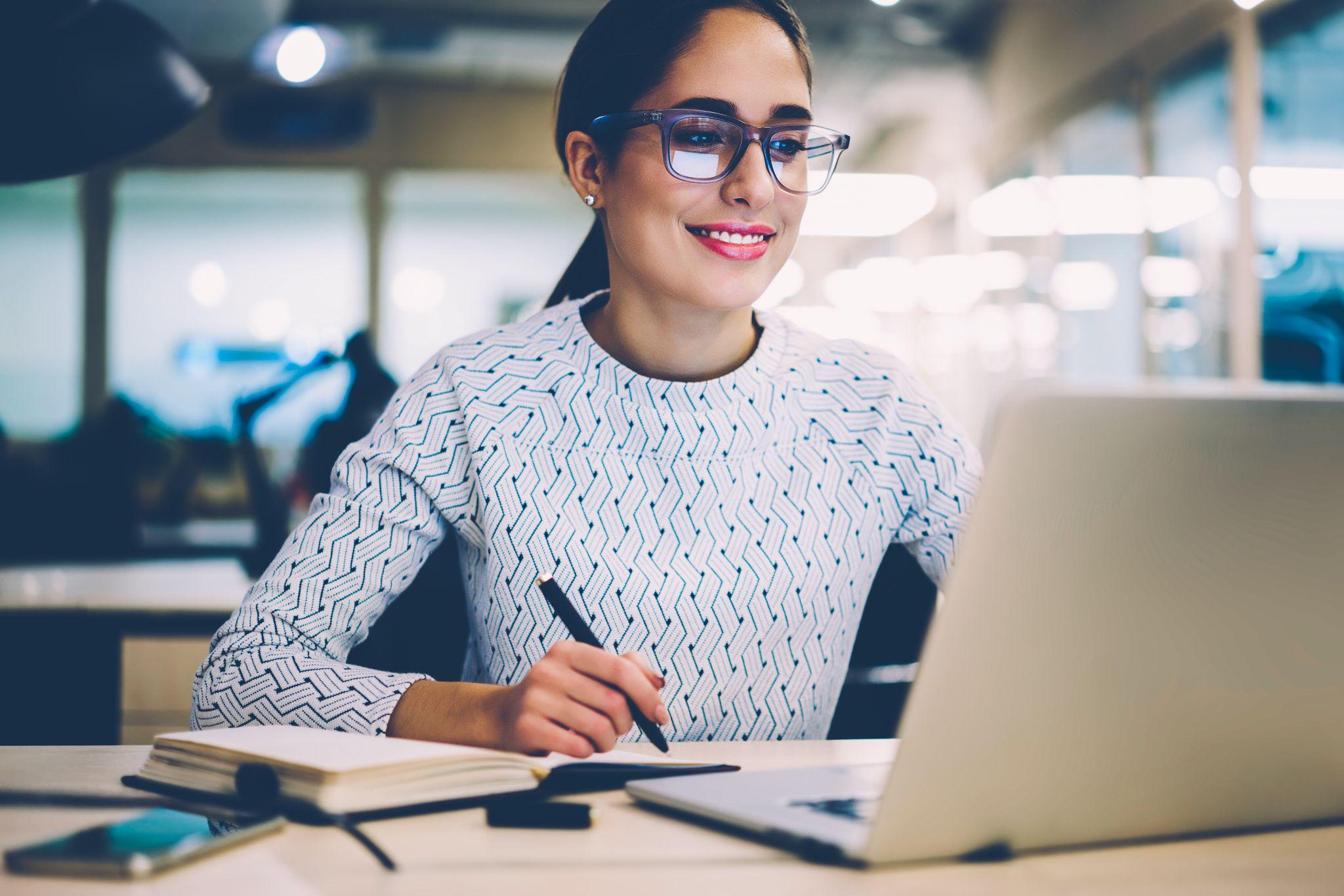 Smart young woman learning during online courses using netbook