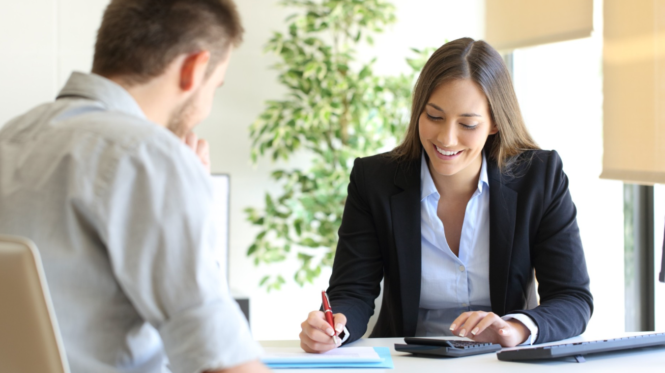 Insurance agent and customer calculating budget